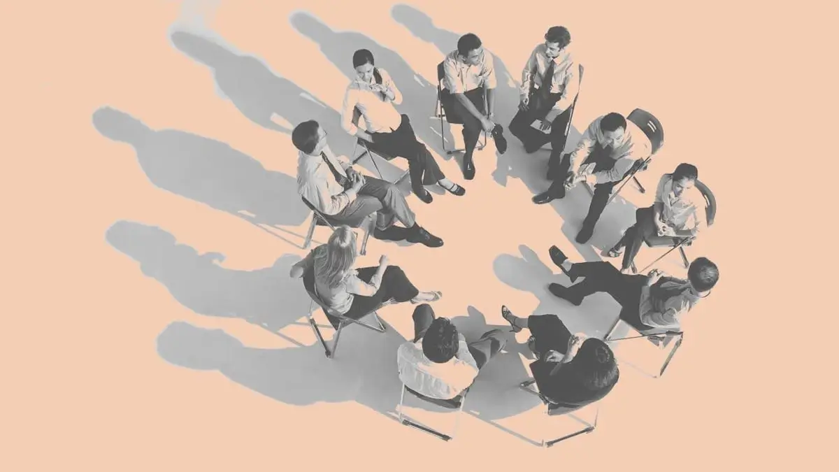 Illustration representing active learning applications and activities by showing a high-angle view of a group of people sitting in a circle discussing, getting feedback, and engaging in guided practice